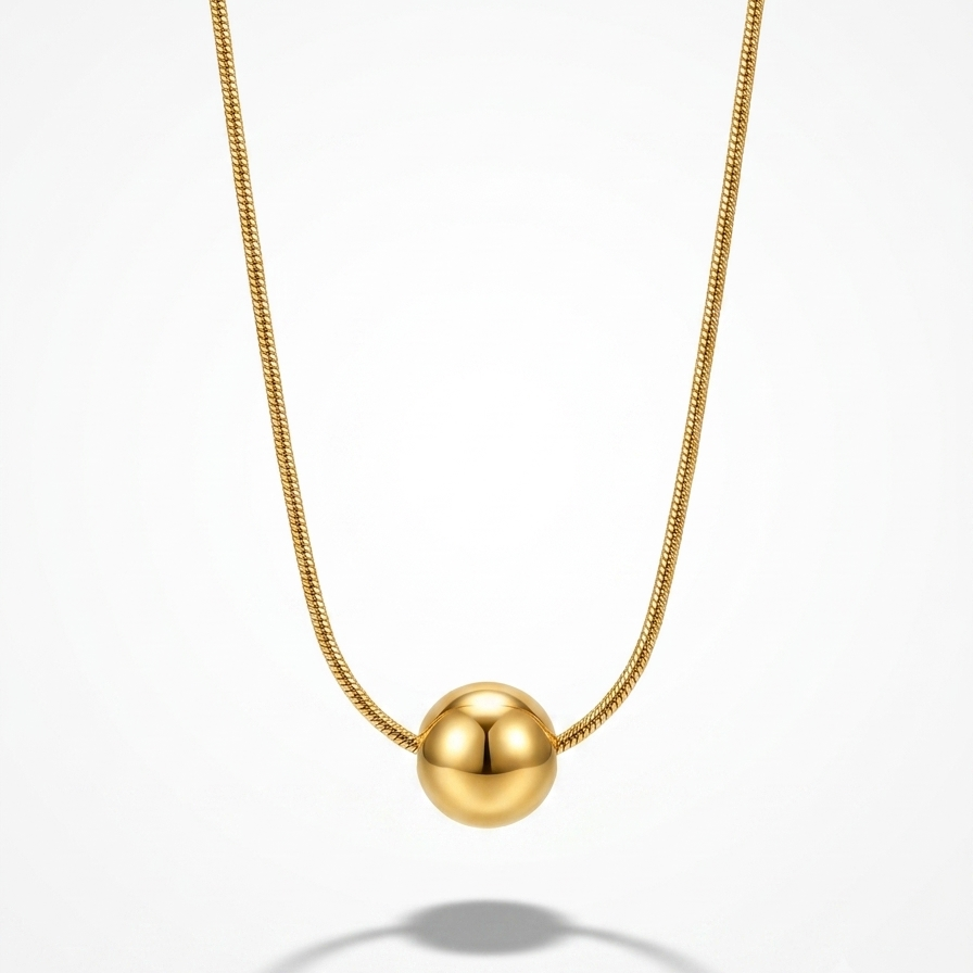 A gold ball pendant necklace on a delicate gold chain, centered against a clean white background with a soft shadow below.
