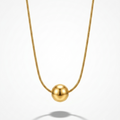 A gold ball pendant necklace on a delicate gold chain, centered against a clean white background with a soft shadow below.