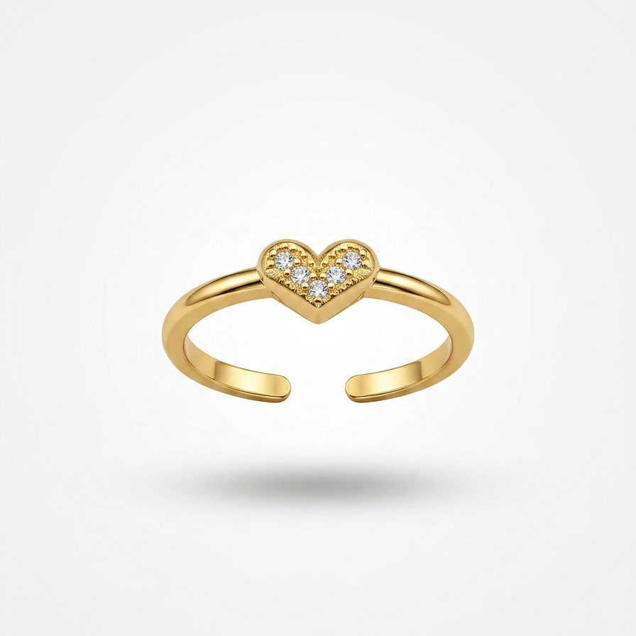 A gold open-bend ring featuring a small heart-shaped cluster of clear stones at the center, shown on a clean white background with a soft shadow.