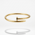 18kt gold plated nail bracelet floating on a white background.