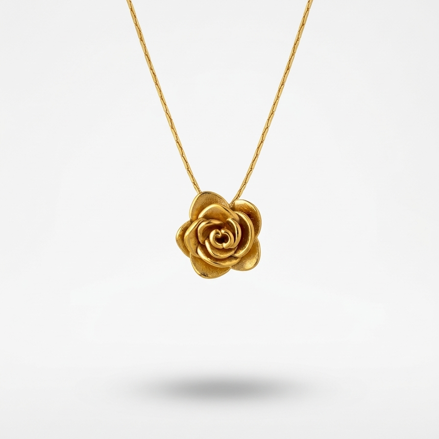 18k gold plated necklace featuring a detailed, sculpted 3D rose pendant on a snake chain, resting on a matte white block.