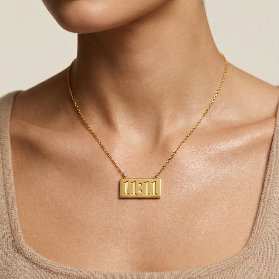 18k gold plated necklace featuring a horizontal rectangular bar pendant engraved with the numbers 11:11 on a neutral background