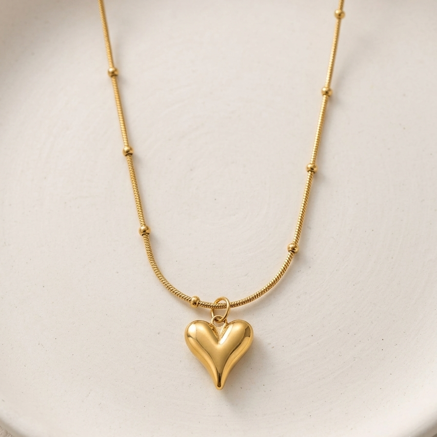 18k gold plated necklace featuring a smooth, 3D puffy heart pendant suspended on a delicate beaded satellite chain.