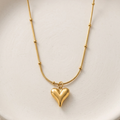 18k gold plated necklace featuring a smooth, 3D puffy heart pendant suspended on a delicate beaded satellite chain.