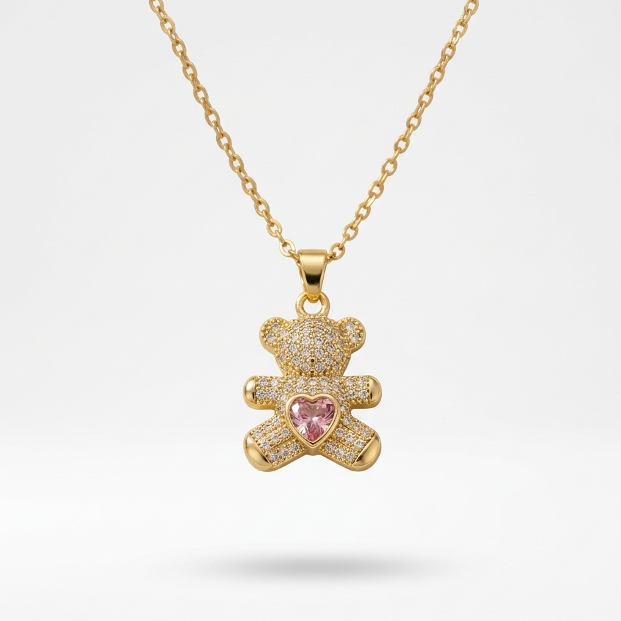 18k gold plated teddy bear pendant necklace fully encrusted with clear CZ diamonds, featuring a pink heart-shaped crystal in the center.