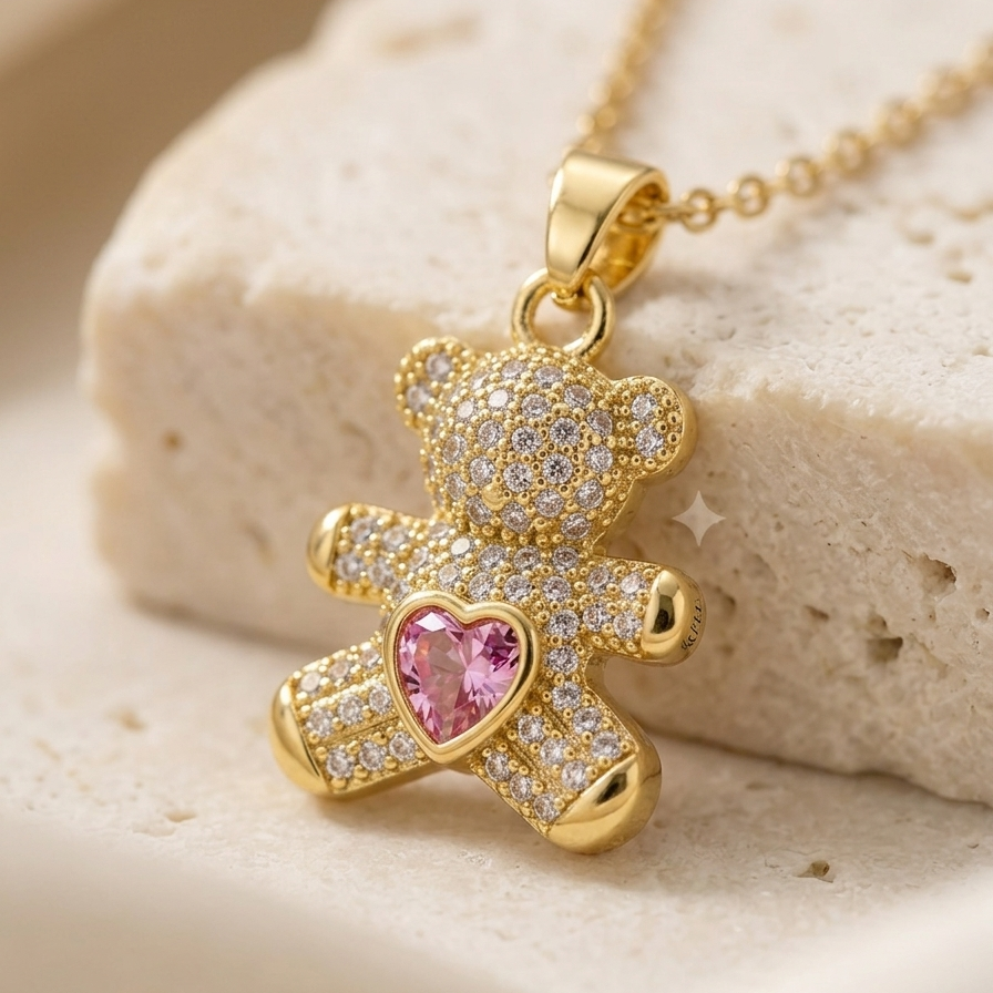 18k gold plated teddy bear pendant necklace fully encrusted with clear CZ diamonds, featuring a pink heart-shaped crystal in the center.