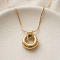 18k gold plated necklace featuring a thick, chunky donut-shaped hoop pendant suspended on a sleek snake chain.