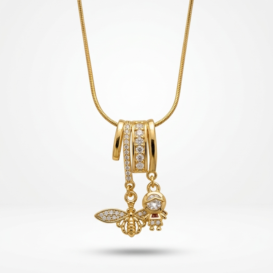 18k gold plated necklace featuring an intricate diamond-encrusted sliding bail holding a detailed golden bee charm and a small figure charm.