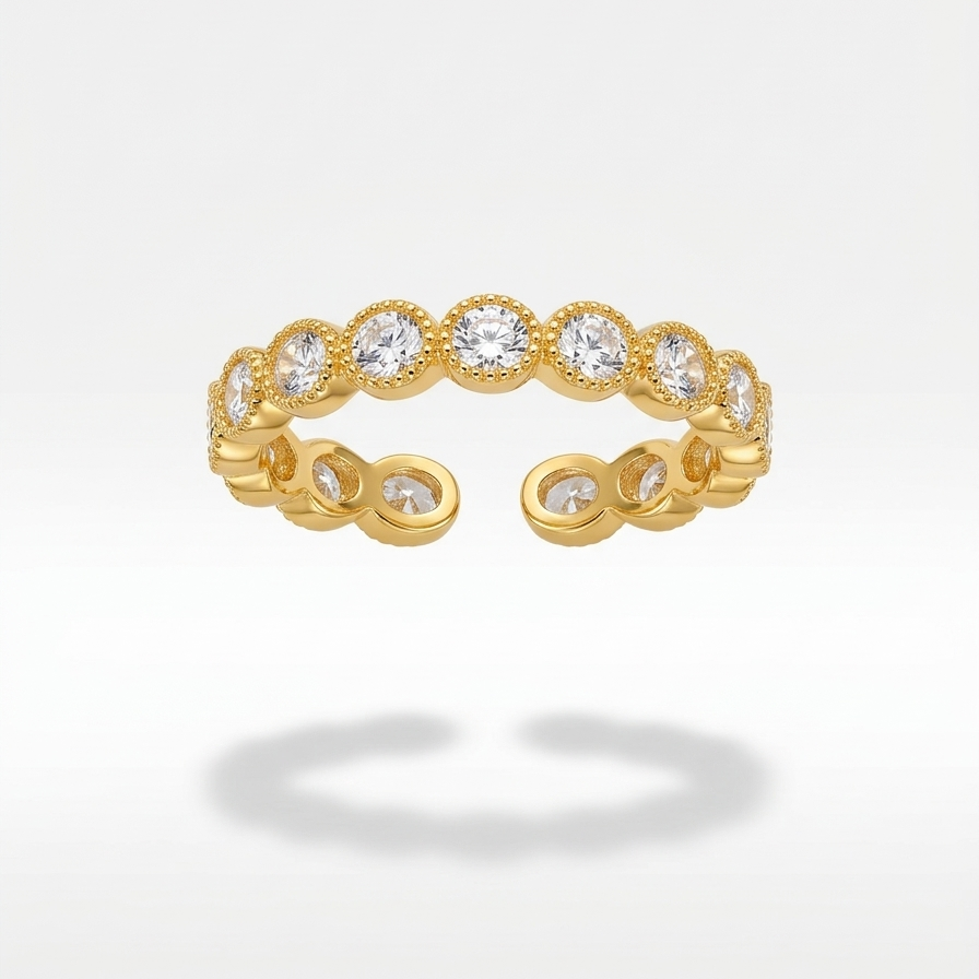 Close up of an 18k gold plated eternity band ring featuring a row of sparkling CZ diamonds with vintage beaded edges.