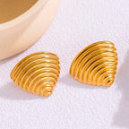 Ribbed gold croissant style triangular stud earrings on white background.