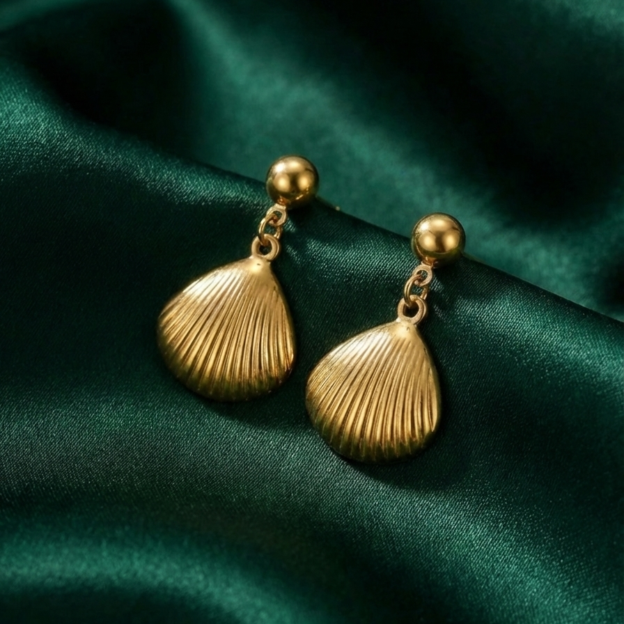 Gold shell drop earrings with scallop charm on white packaging card