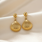 Gold shell drop earrings with scallop charm on white packaging card