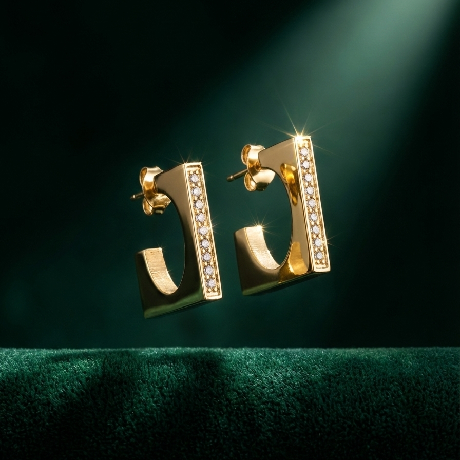 Rectangular gold hoop earrings with crystal pavé details on white background.